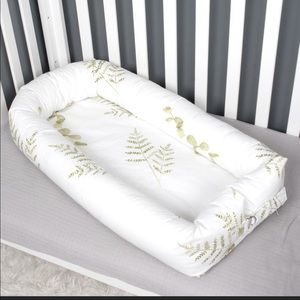 Baby or toddler nest, white with green leaves